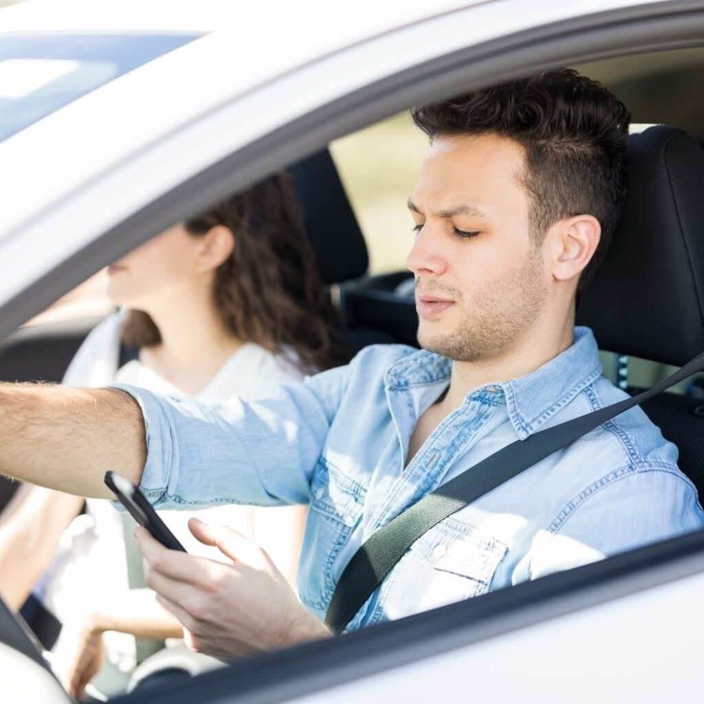 a man is using phone while driving